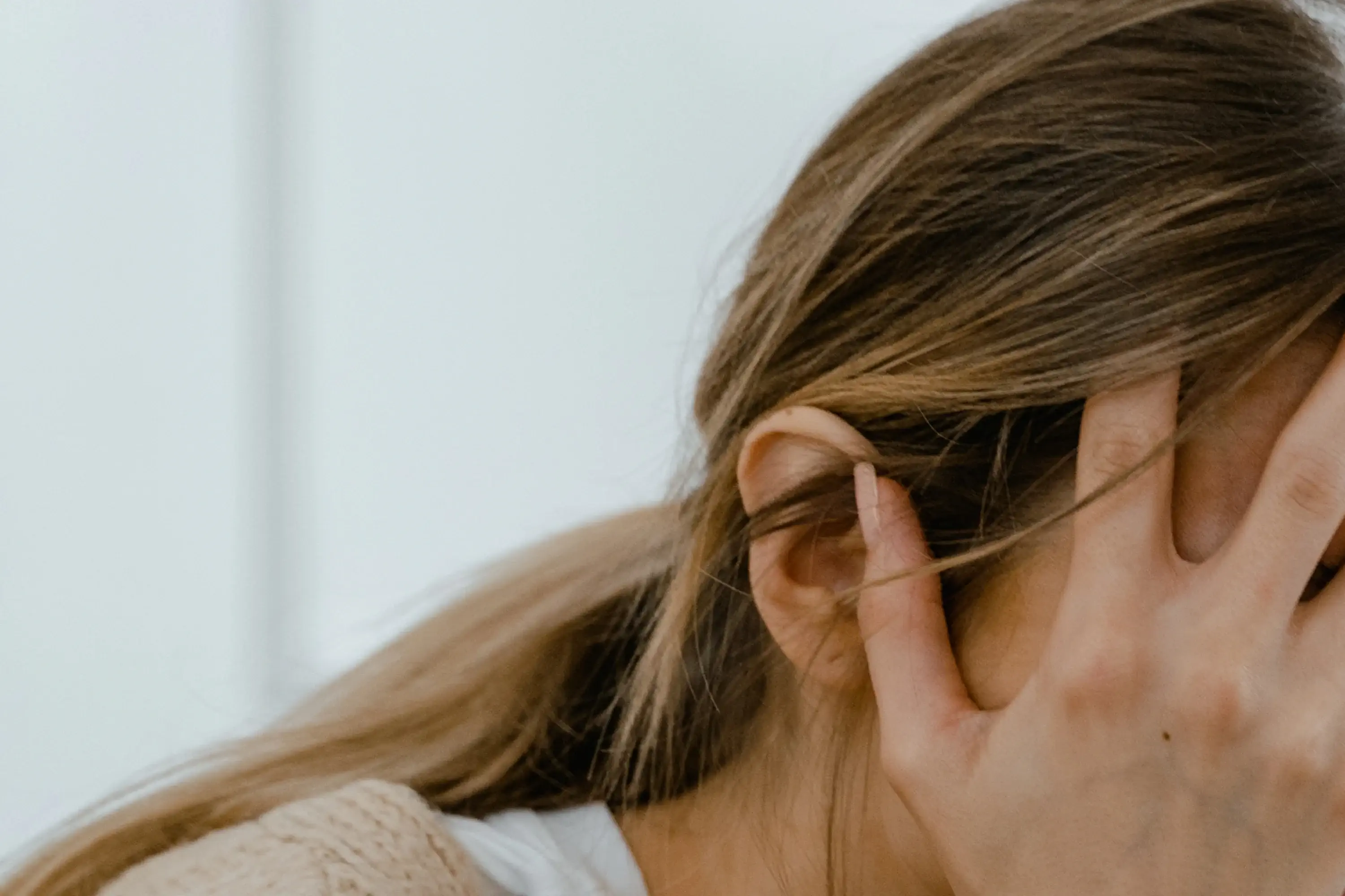 woman with her hand on her forehead